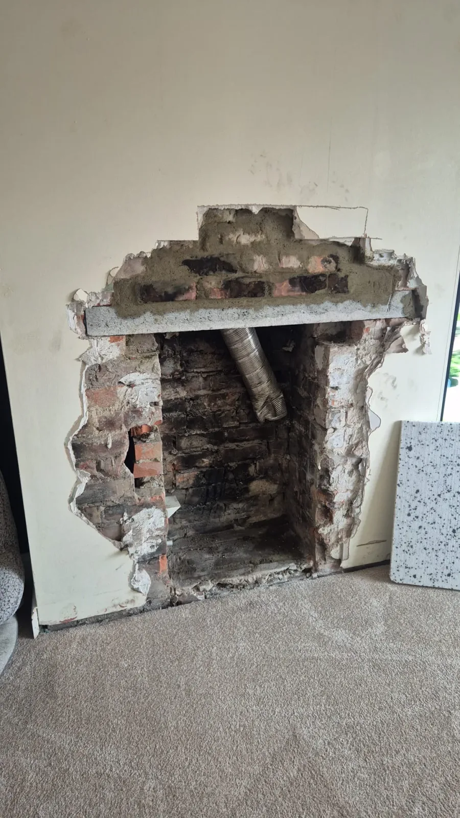 Exposed brickwork during preparation of the fireplace opening