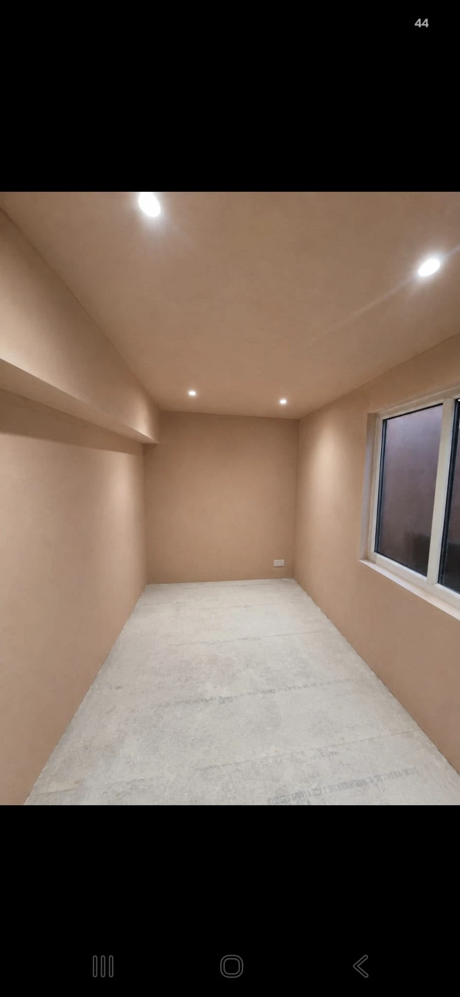 The room with a smooth plaster finish on the walls and ceiling